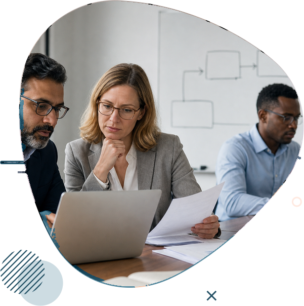 Consultants collaborating on a project around a laptop